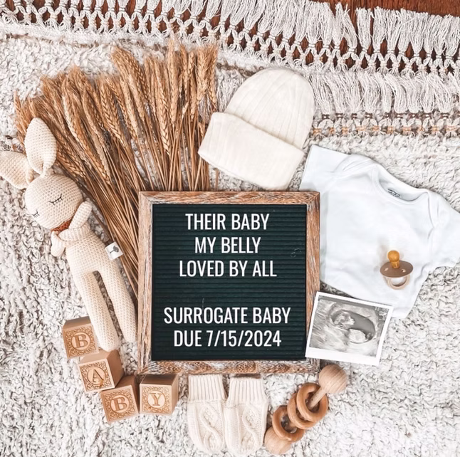 Surrogate with baby announcement board