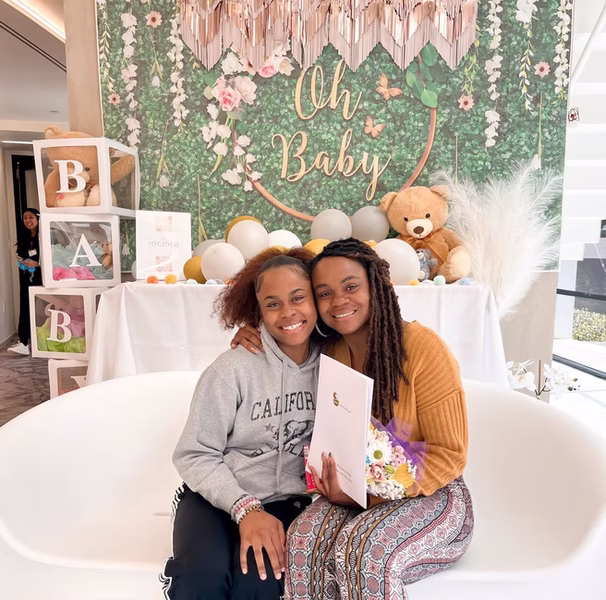 Surrogate with intended parents at baby shower